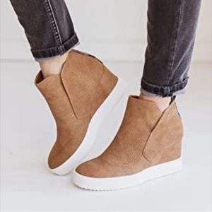 Brown wedge booties with cute detailing on back.